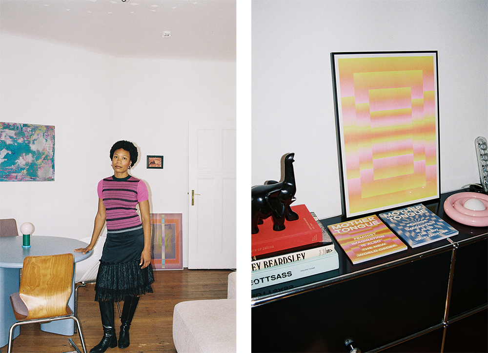Two photos: the photo on the left is a photo of Sophie Douala. She is standing in the middle of a room, leaning her hand lightly on a light blue round table. Behind her, on the wall and on the floor, are two colorful prints. In the photo on the right, you can see a small cabinet with several items on it: a stack of books with a small elephant figure on top, two magazines (both designed by Sophie Douala), a pink lamp, and a framed print (designed by Sophie Douala).